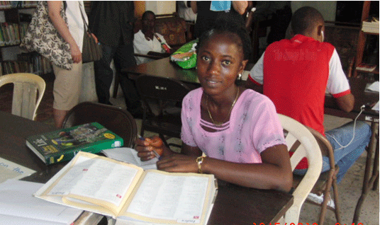 A young girl immersed in study at Wee-Care Library—beautiful place, beautiful face, and a real desire for scholarship